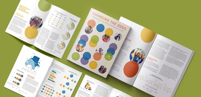 Annual report design showcase with colorful infographics and data visualizations spread across multiple open report pages
